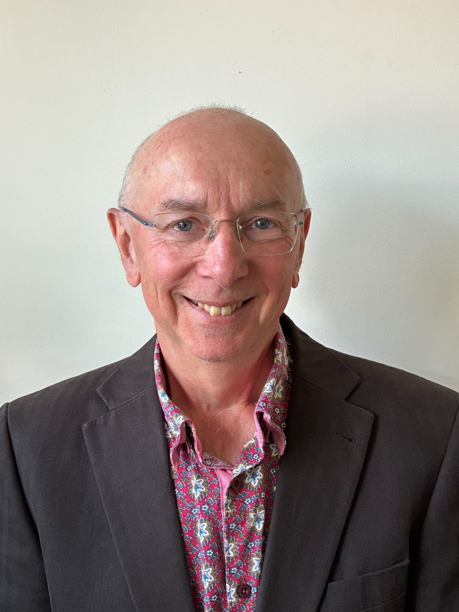 Picture of a Person wearing glasses, shirt and jacket